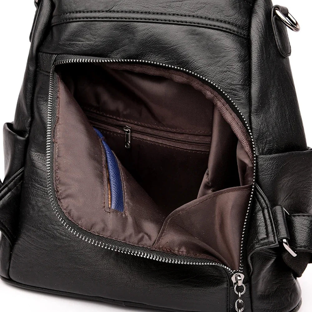 Sac à dos en cuir noir pour femme avec poche frontale zippée et pochette bleue intérieure