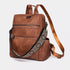 Sac à dos en cuir vintage marron avec plusieurs poches zippées et sangle brodée