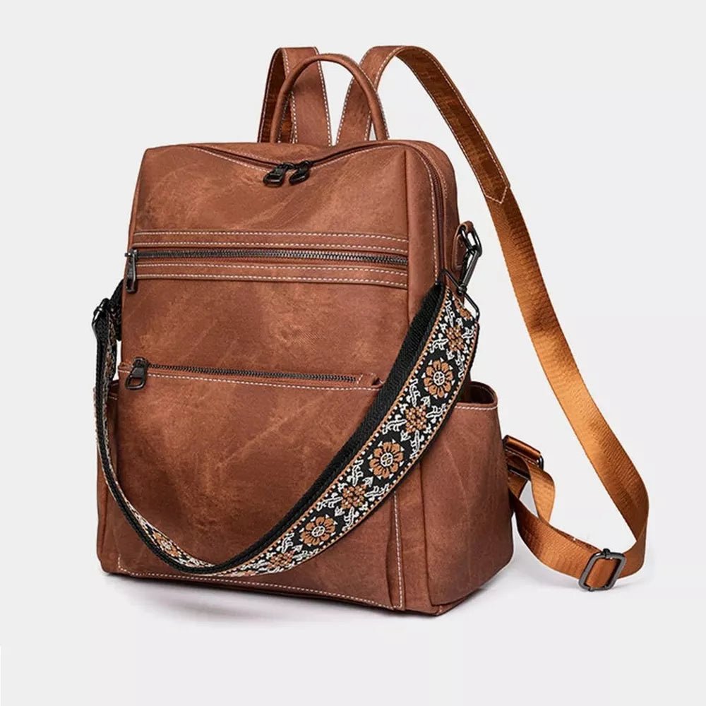 Sac à dos en cuir vintage marron avec plusieurs poches zippées et sangle brodée
