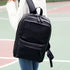 Sac à dos en cuir synthétique noir avec plusieurs compartiments zippés pour femmes