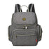 Sac à dos à langer gris avec plusieurs compartiments zippés et poignées supérieures