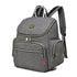Sac à dos à langer gris en tissu avec plusieurs compartiments zippés et bretelles rayées noir et blanc