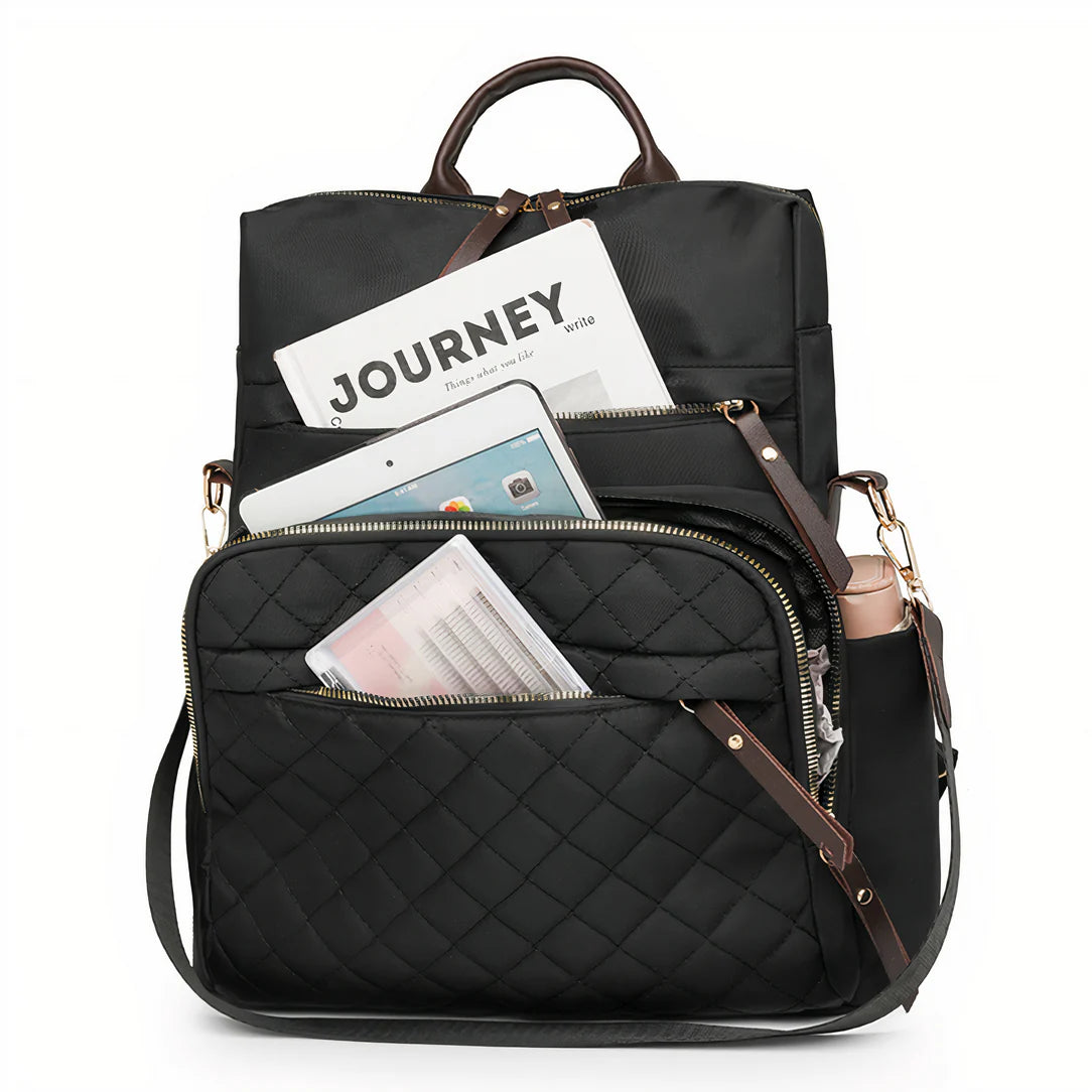 Sac à dos effet matelassé Céleste noir avec accents en cuir marron et détails de fermeture éclair