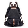 Sac à dos en tissu minimaliste noir avec accents en cuir marron et poche frontale