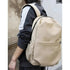 Sac à dos homme tendance beige en toile avec bordure noire pour style moderne