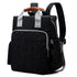 Sac à dos à langer bébé en cuir noir avec poignée marron et accents argentés