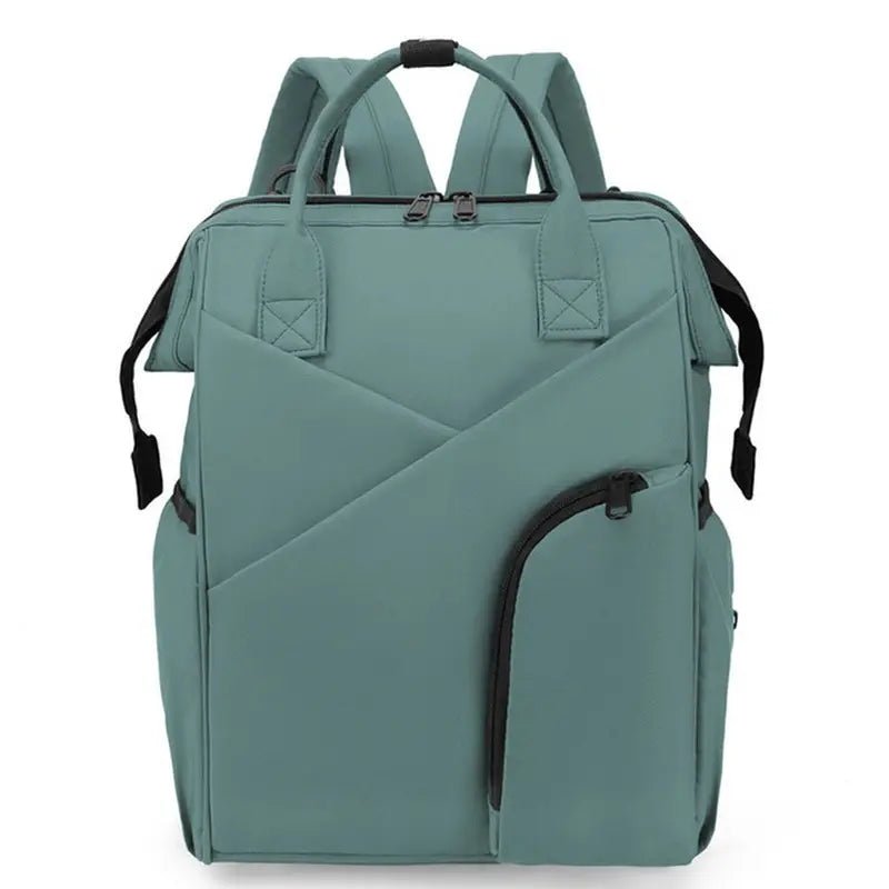 Sac à dos à langer chic en teal avec plusieurs compartiments et poignée supérieure