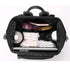 Sac à dos à langer design noir ouvert avec essentiels pour bébé et ordinateur portable