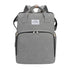 Sac à dos à langer extensible en tissu gris avec plusieurs compartiments et poignées supérieures