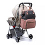 Poussette avec sac à langer le Queen rose et gris attaché à la poignée
