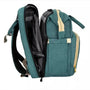 Sac à dos à langer lit en vert teal avec accents beige et plusieurs compartiments