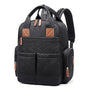 Sac à dos sac à langer noir en quilting avec accents en cuir marron et multiples poches
