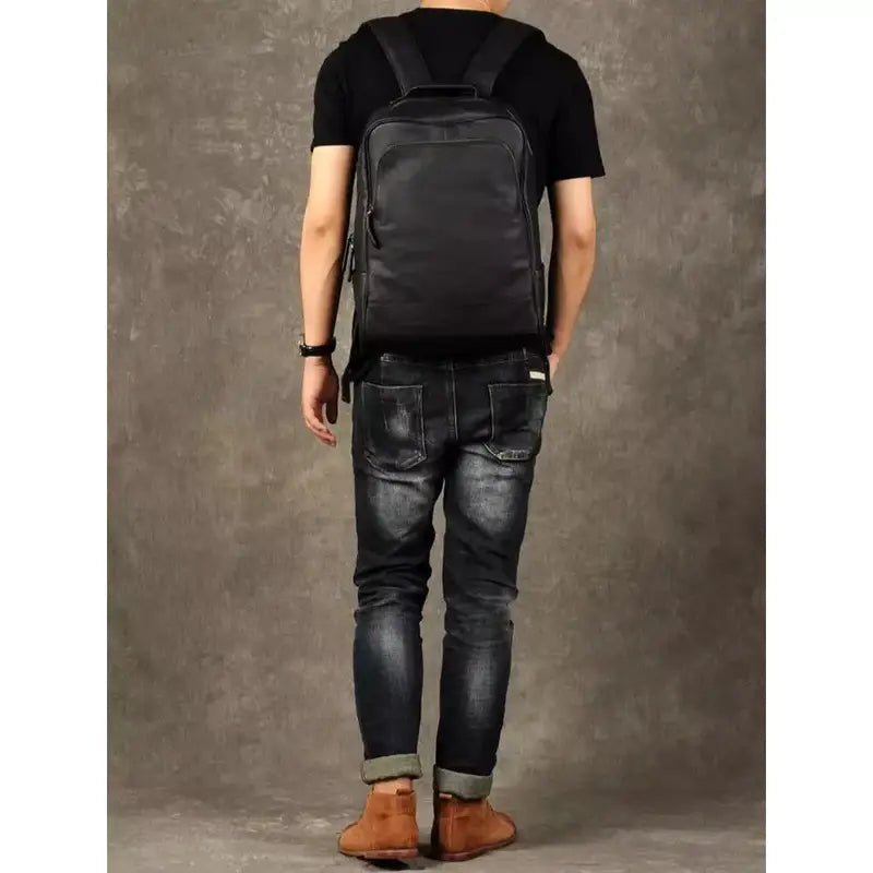 Sac à dos noir en cuir véritable porté sur le dos d’une personne
