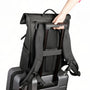 Sac à dos roll top noir avec pass-through pour bagage sur une valise