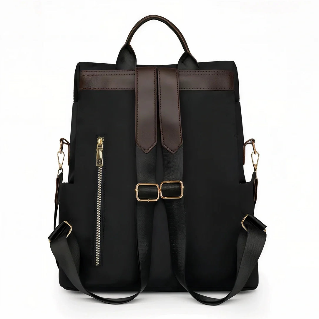 Sac à dos Sirocco en toile noire avec accents cuir marron et quincaillerie dorée