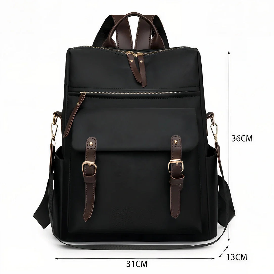 Sac à dos Sirocco en toile noire avec accents cuir marron et quincaillerie dorée