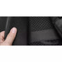 Main tenant touchant un tissu en maille noire avec un sac à dos voyage ordinateur en arrière-plan