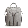 Sac à langer sac à dos gris en tissu avec poches zippées et poignées supérieures