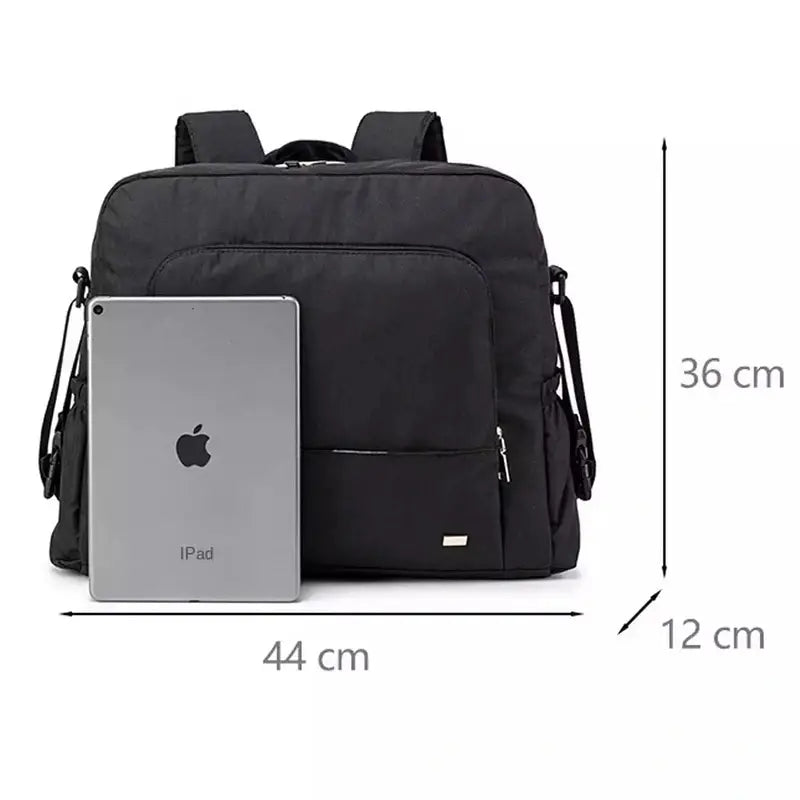 Sac à langer à dos noir avec bretelles, poche extérieure et espace pour tablette