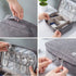 Organisateur de voyage multifonction en tissu gris avec compartiments pour électroniques